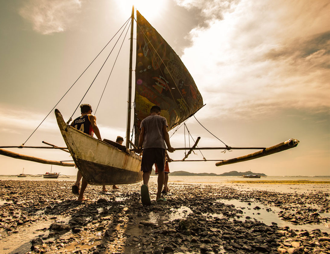 A local team gets ready to join a paraw race. These paraws – a Filipino sailboat – are also used by many for fishing